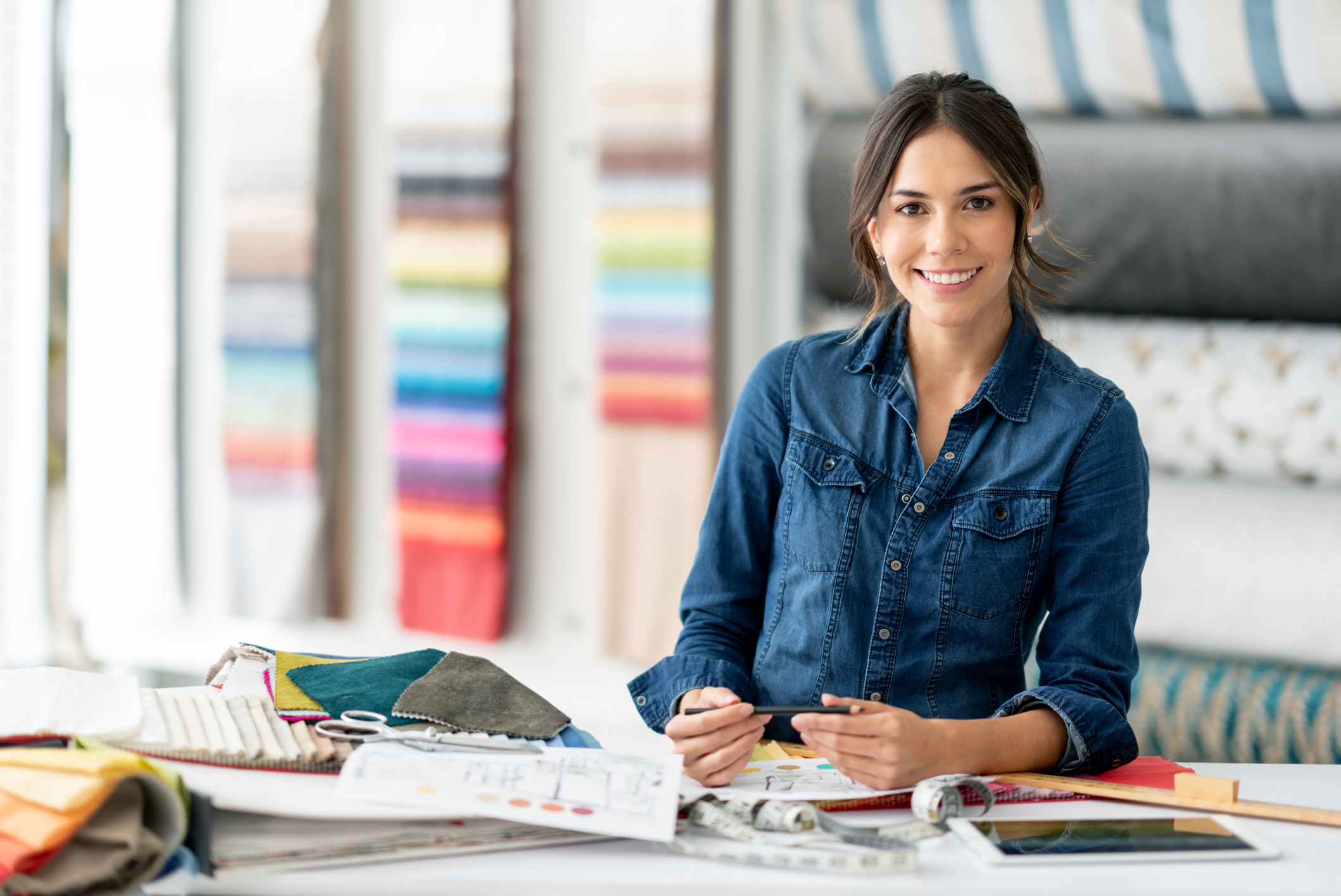 Interior designer working at her workshop choosing fabrics