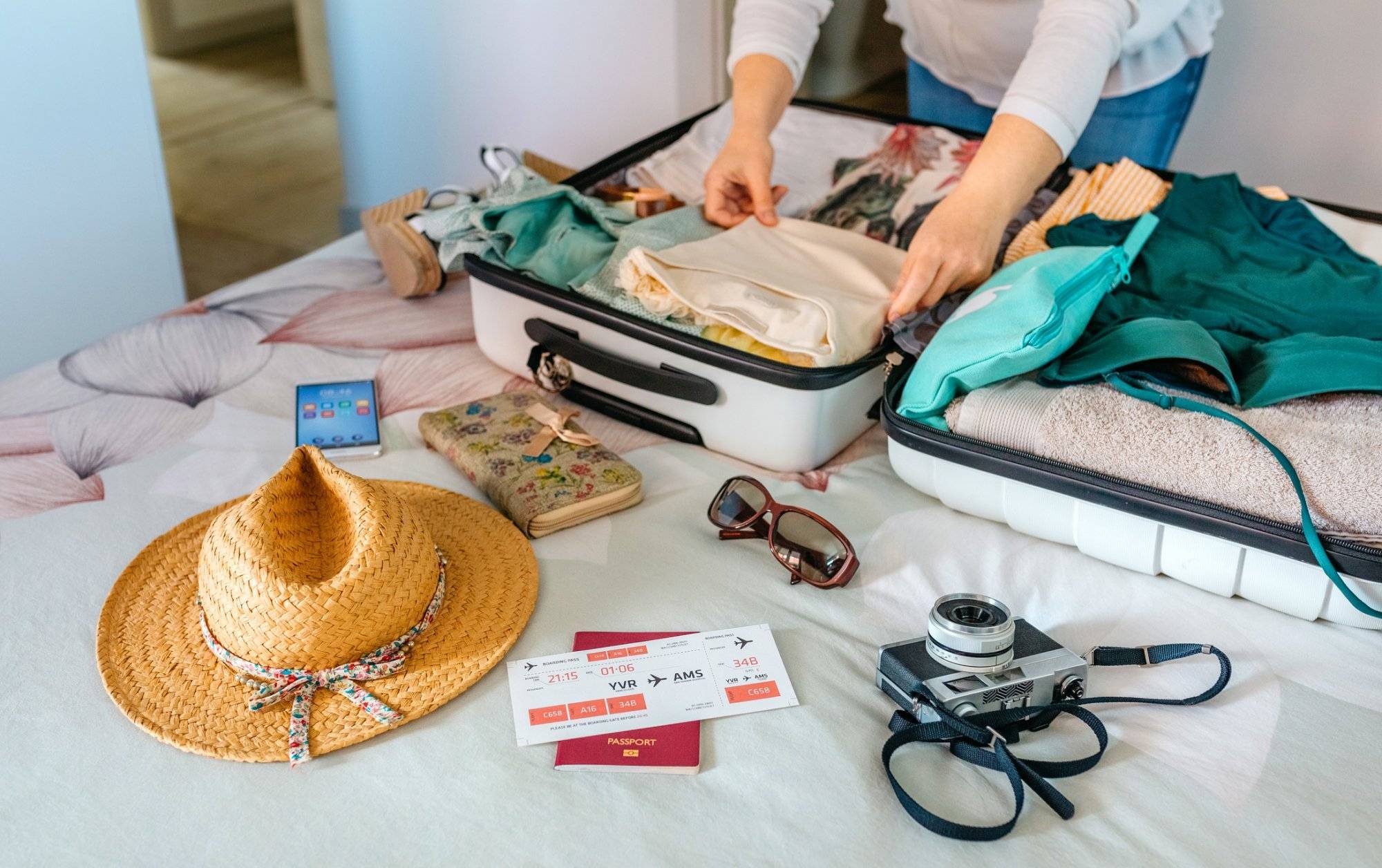 Unrecognizable woman preparing suitcase for summer holidays Unrecognizable woman preparing suitcase for summer holidays
