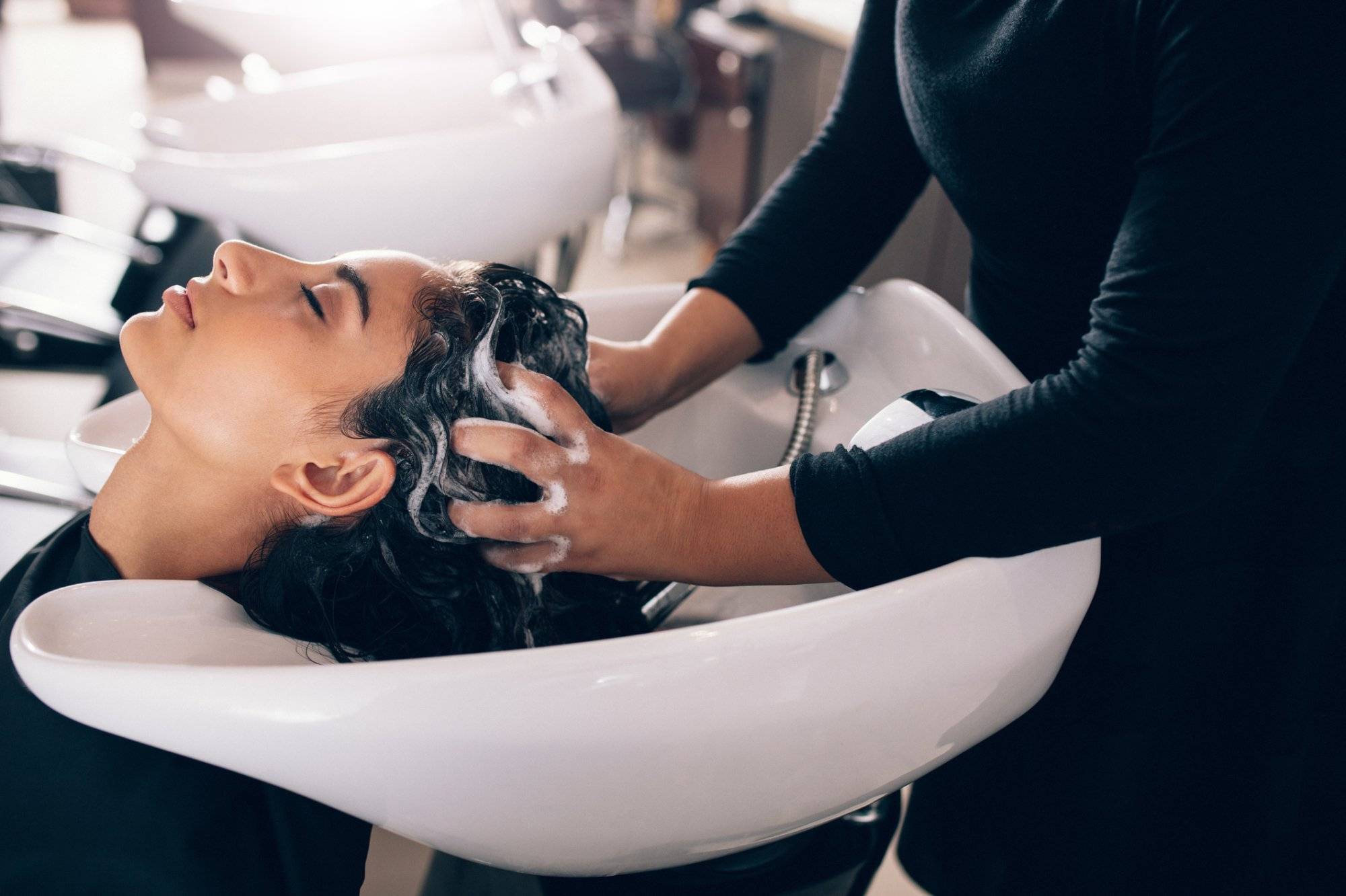 Woman getting hair shampooed at salon Woman getting hair shampooed at salon