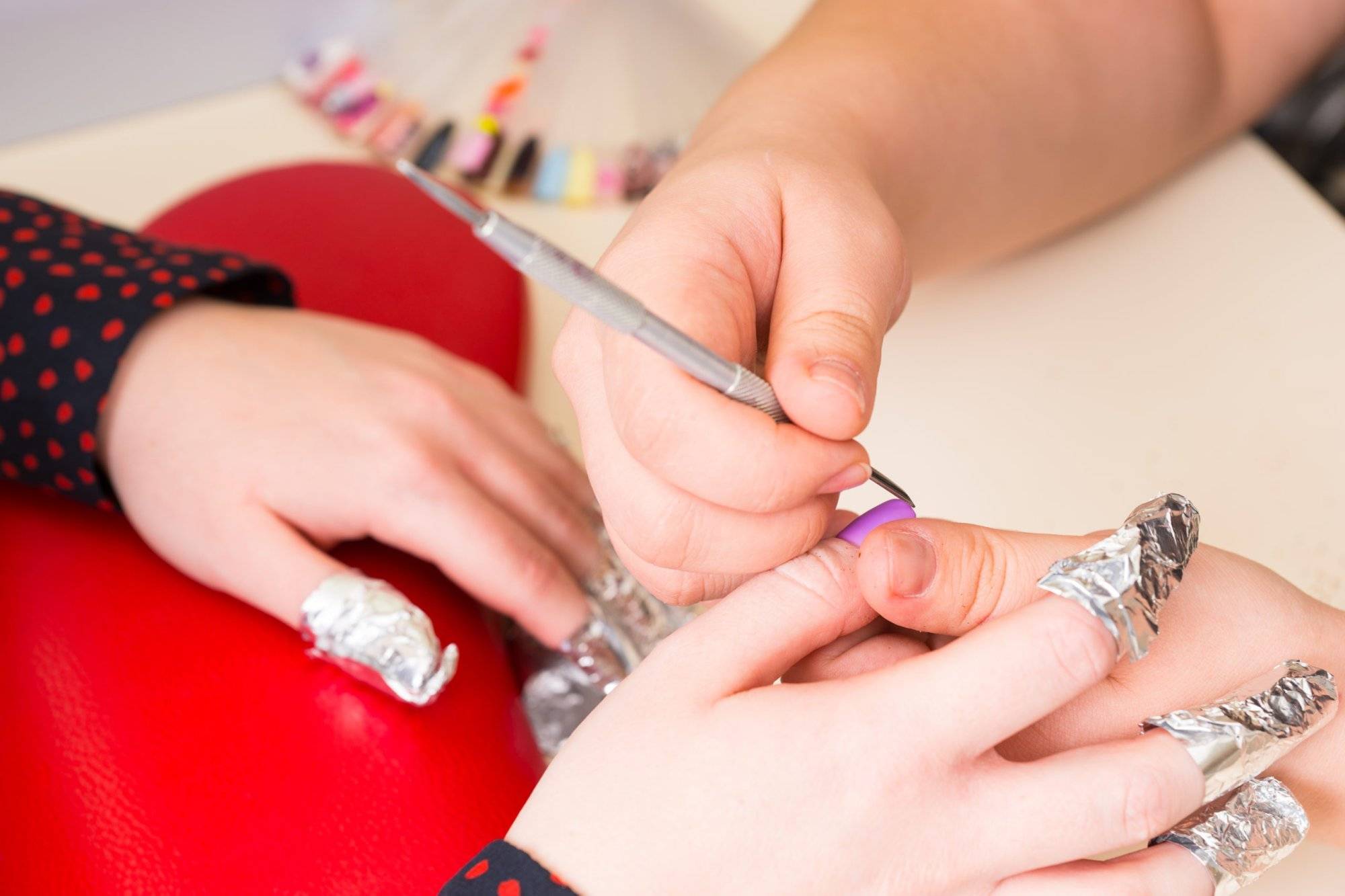 Manicurist Shaping Finger Nails with Tool in Spa Why Carousel Nails Boutique Has the Best Nail Services in Grapevine